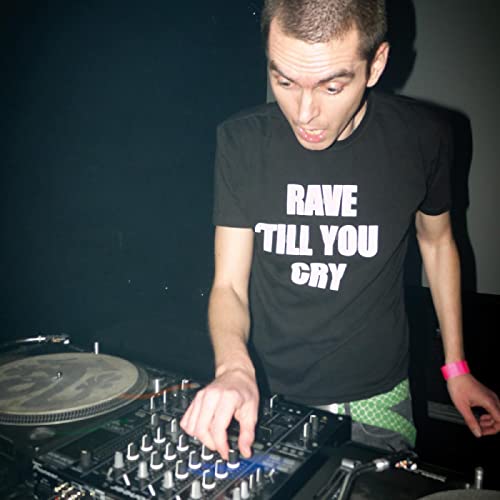 Bogdan Raczynski at turntables, wearing a shirt reading “Rave Till You Cry”.