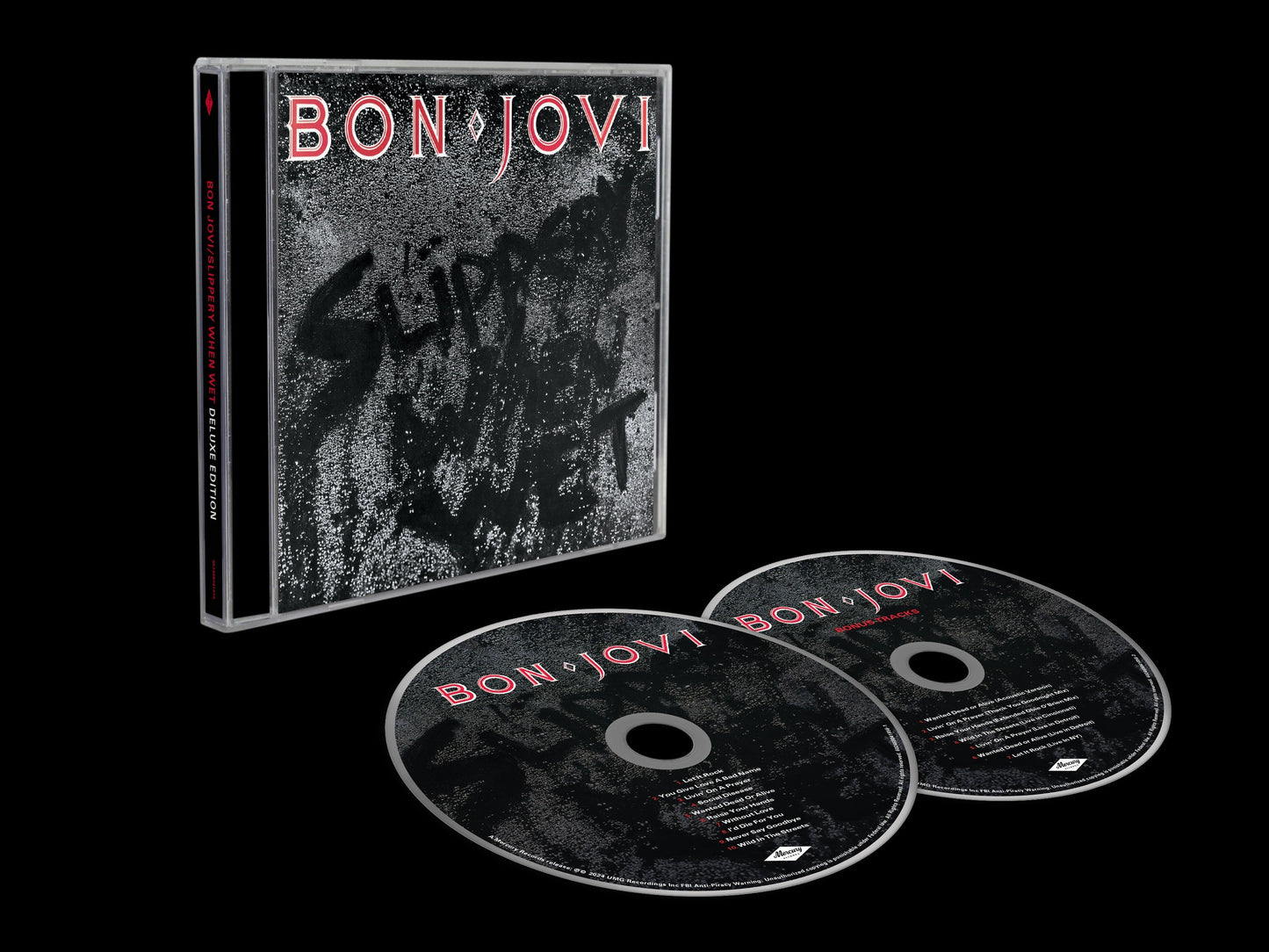 Bon Jovi "Slippery When Wet" CD case with two discs, black background.