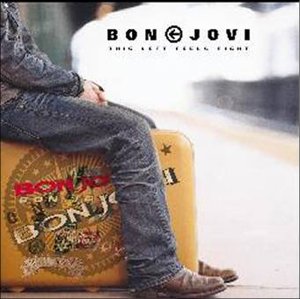 Bon Jovi album cover featuring a man sitting on a vintage suitcase.