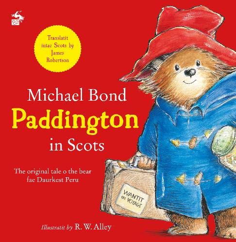 Paddington Bear with a red hat and blue coat on a red background.