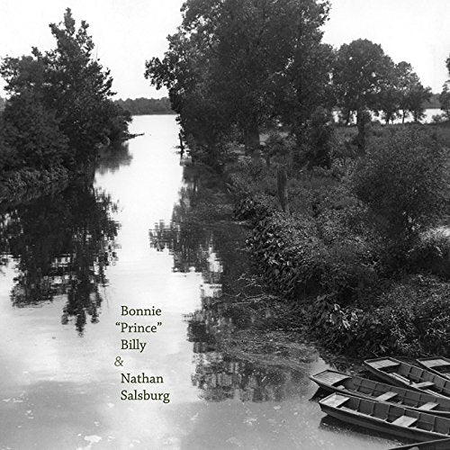 Black and white landscape with river, trees, and small boats; album text.