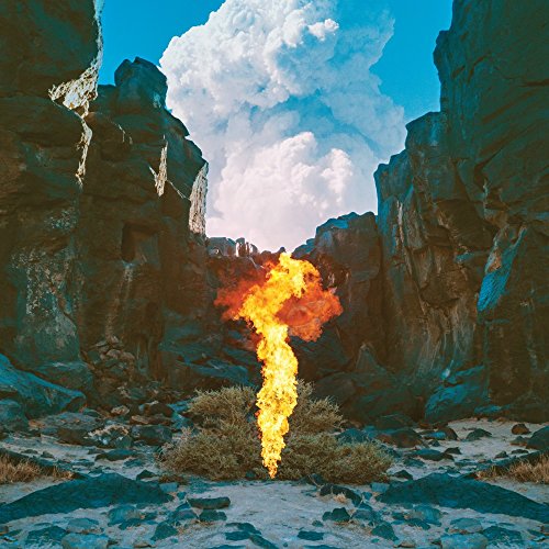 CD cover: desert landscape with a large plume of orange flames.