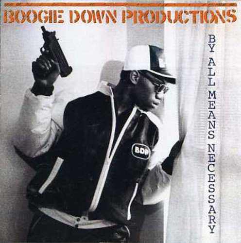 KRS-One holding a submachine gun while peering through a window curtain.