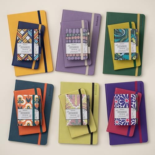 Six small notebooks with pens, in various colors and patterns.