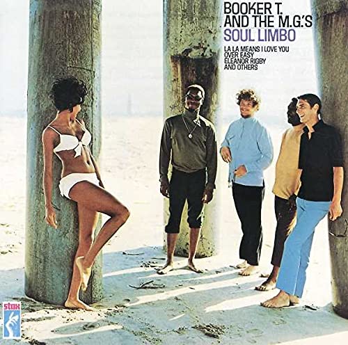 Four men and one woman standing by beach pillars, woman wearing white bikini.