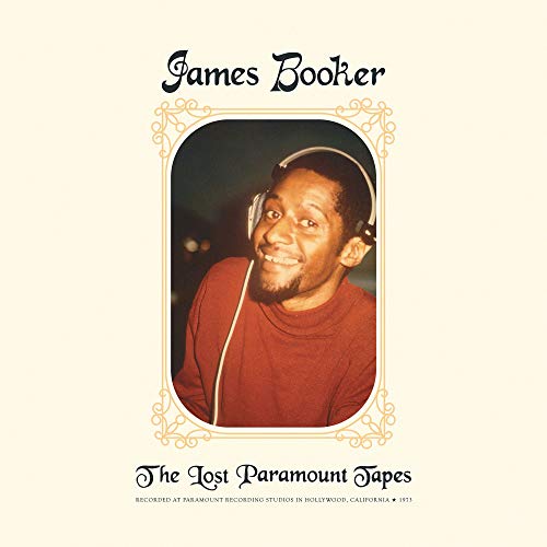 "Vinyl album cover with a man wearing headphones, surrounded by ornate design."