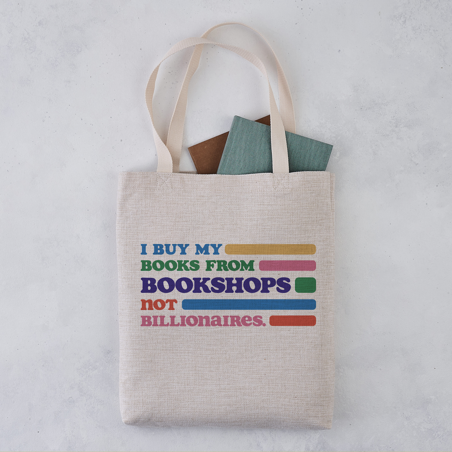 Natural canvas tote bag with books inside, printed with the text I BUY MY BOOKS.