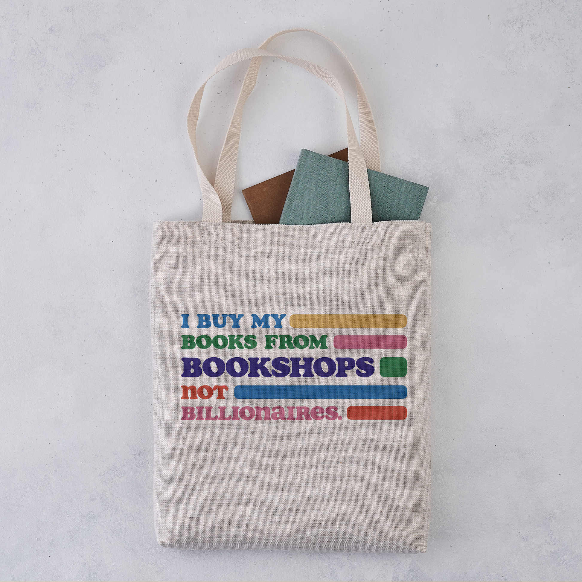 Natural canvas tote bag with books inside, printed with the text I BUY MY BOOKS.