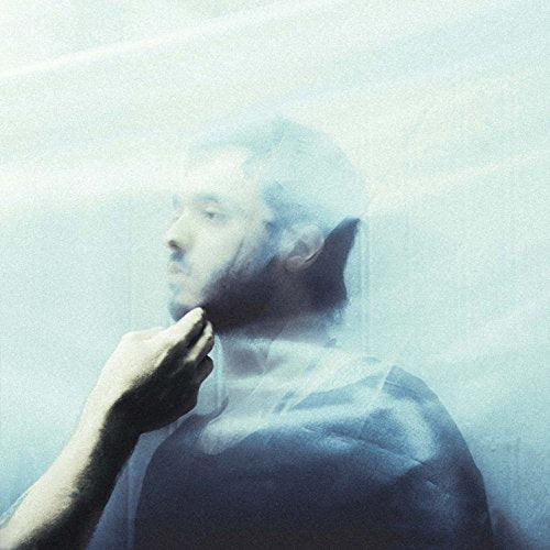 A man seen through a translucent veil with a hand touching his chin.