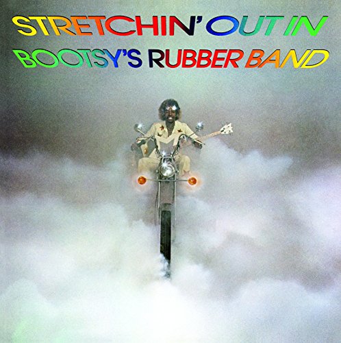 Album cover: Musician on a motorcycle emerging from white fog.