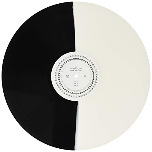 Black and white vinyl record with a central label and text.