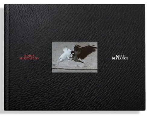 Black leather book cover with two birds and text, white background behind book.