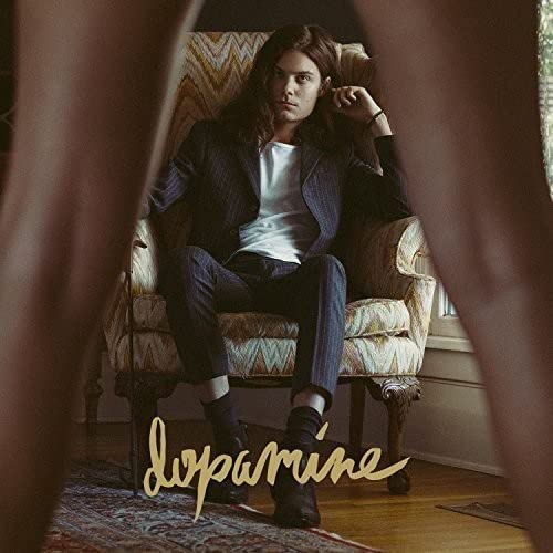 Man in suit sits in ornate chair, album title "Dopamine" below.