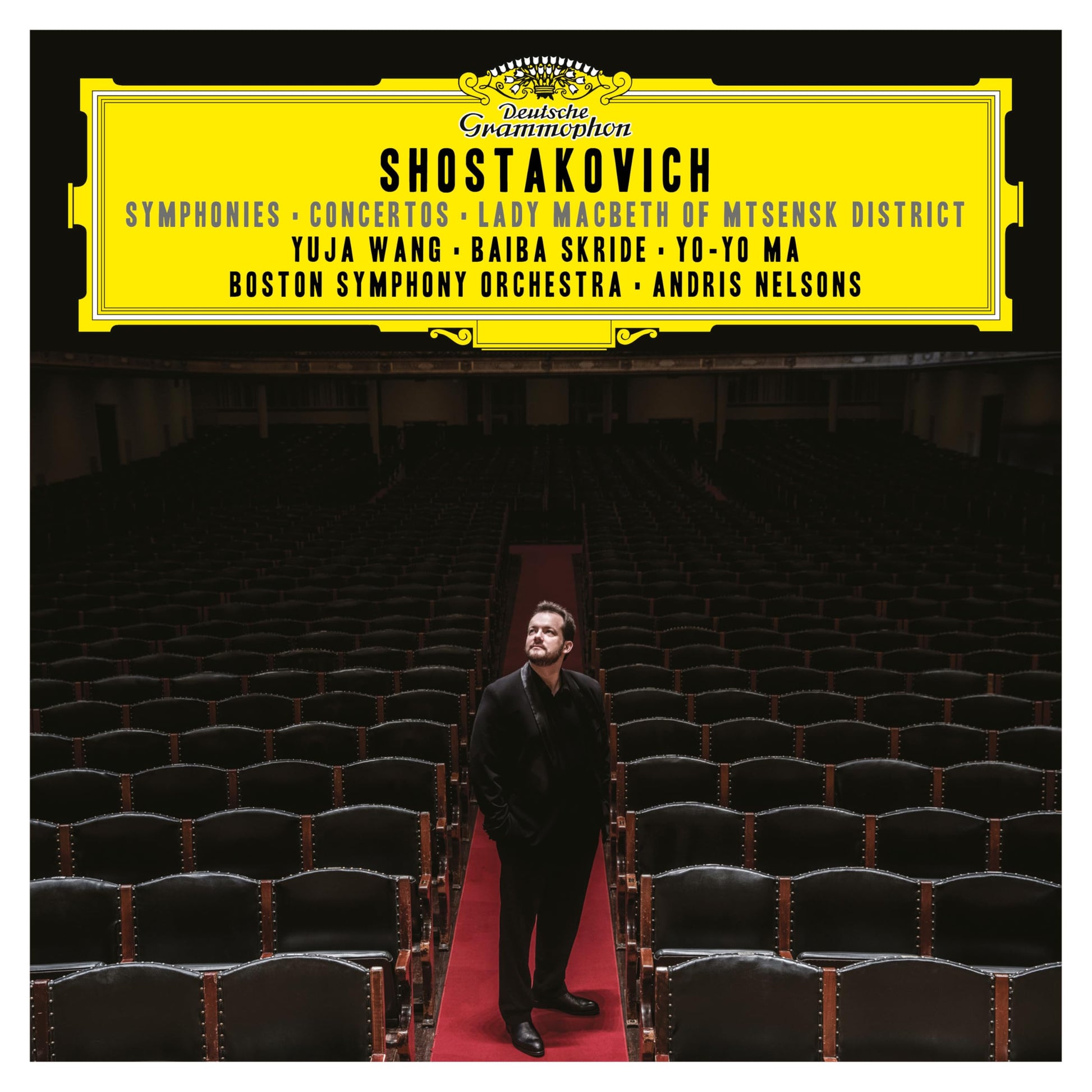 Andris Nelsons standing in an empty concert hall on a Deutsche Grammophon album cover.
