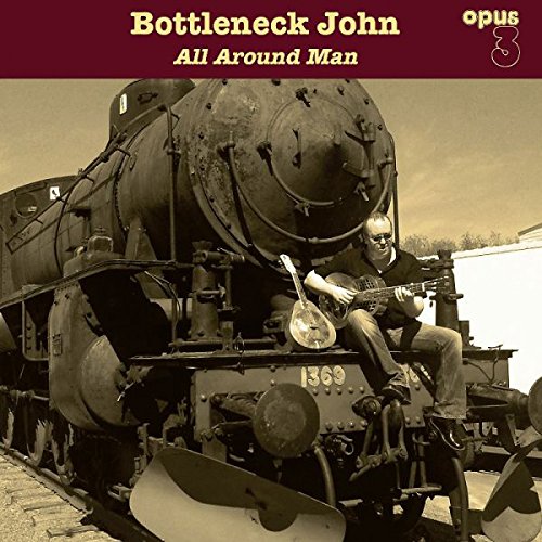 "Album cover featuring a man playing banjo on a train engine."