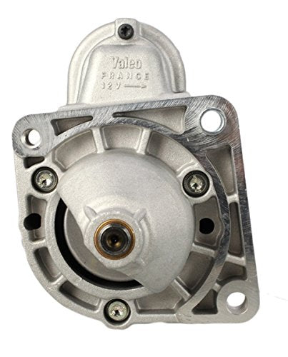 Silver automotive starter motor with visible bolts and a cylindrical center.