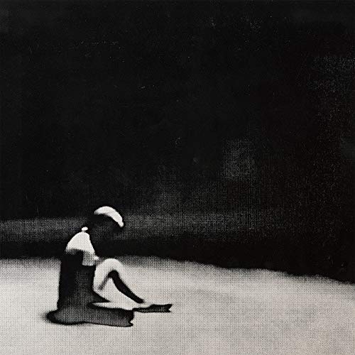 Black and white album cover depicting two figures in a sparse landscape.