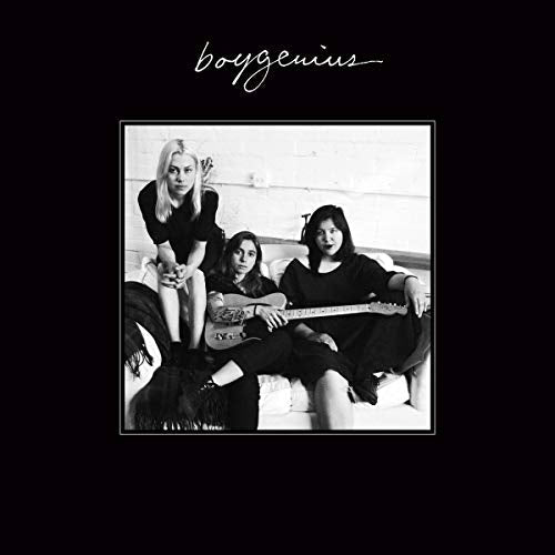 Black and white photo of three women with a guitar, album cover.