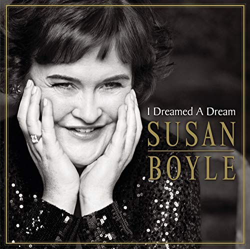 Susan Boyle’s album cover, a portrait of her smiling with hands framing her face.