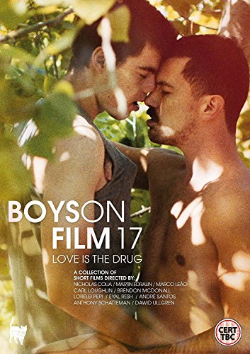 Two men embrace closely outdoors with foliage in the foreground and text overlay.