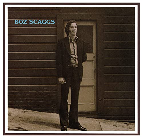 Boz Scaggs standing in front of a wooden door on the album cover.