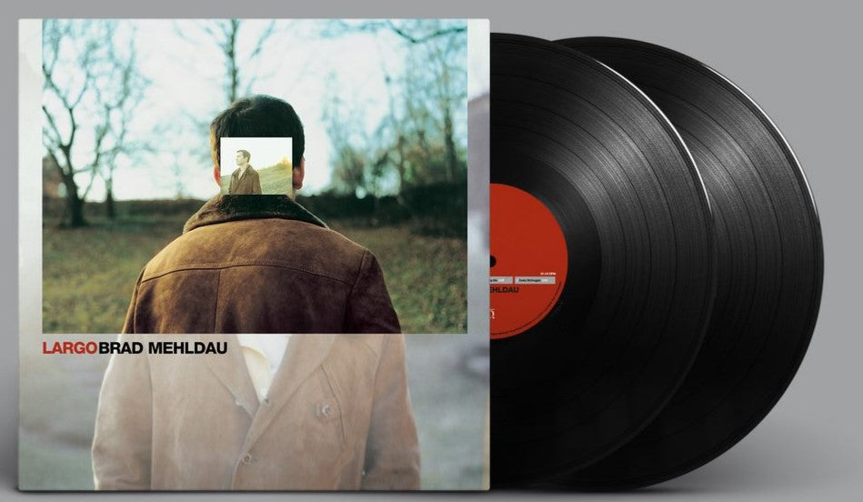 Brad Mehldau's "Largo" vinyl record with a man and trees album cover.