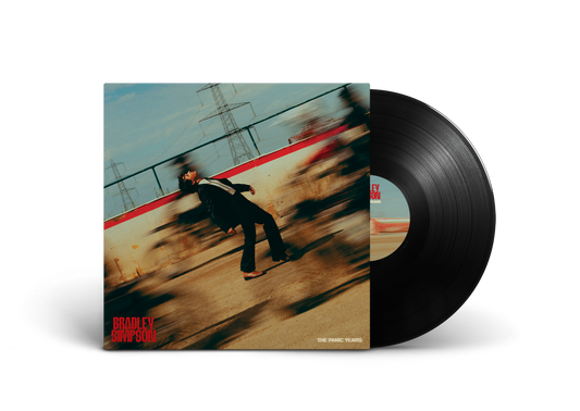 Vinyl record with album cover featuring a man running and power lines.