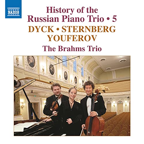 "CD cover featuring three musicians in formal attire posing with their instruments indoors."