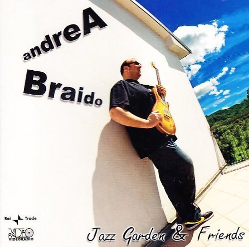 CD cover: Musician with bass guitar against a white wall and blue sky.