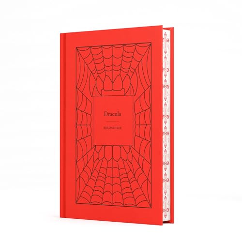 A red hardcover book titled Dracula with a black spiderweb design on the cover.