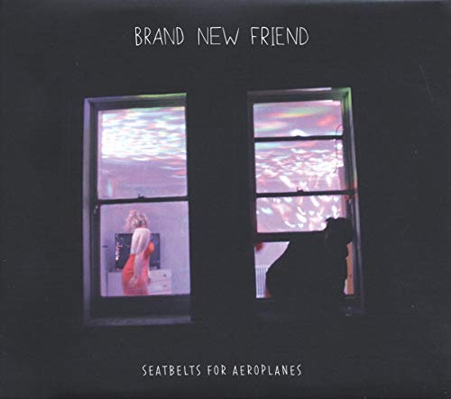 Vinyl album cover with dark windows reflecting a woman in a red dress.