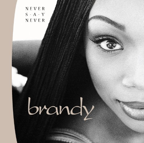 Black and white close-up portrait of Brandy with the album title Never Say Never.