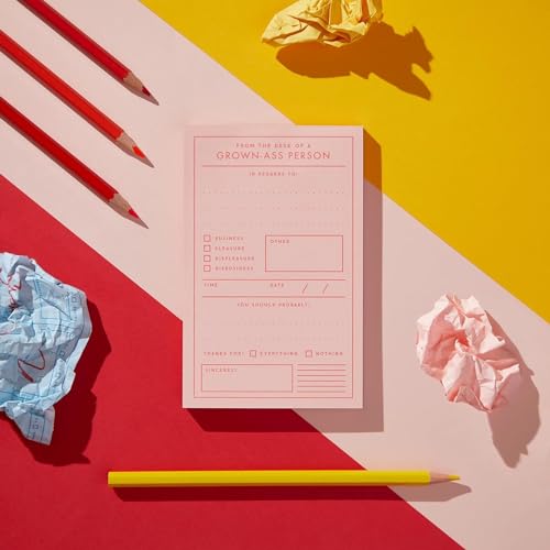 Pink memo pad with checklist, surrounded by crumpled paper and pencils.