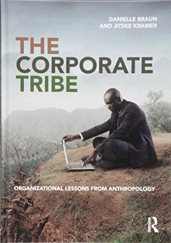 Book cover showing a man in a suit using a laptop in a landscape.