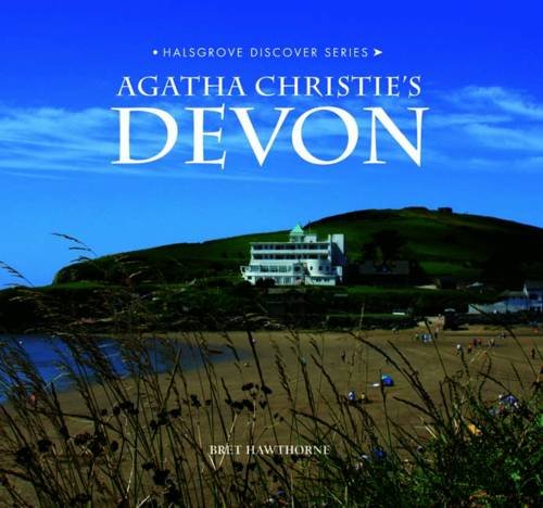 Book cover showing a white building on a green hill by a sandy beach.