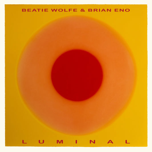 Album cover for "Luminal" by Brian Eno & Beatie Wolfe, featuring a red and yellow circle.
