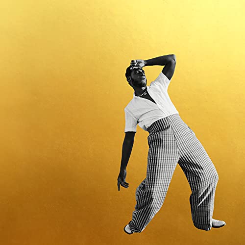 Vinyl record cover with man in white shirt and striped pants on gold background.