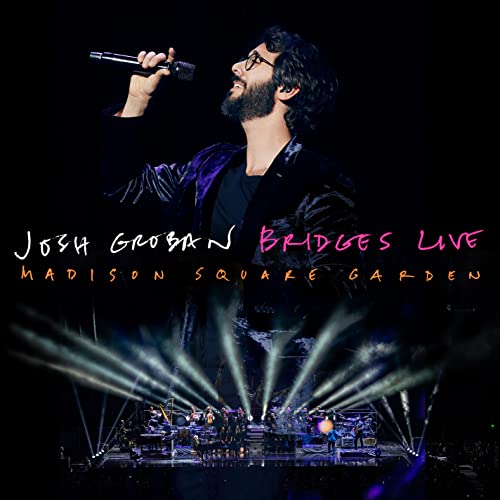 Josh Groban performing live at Madison Square Garden, stage lights visible.