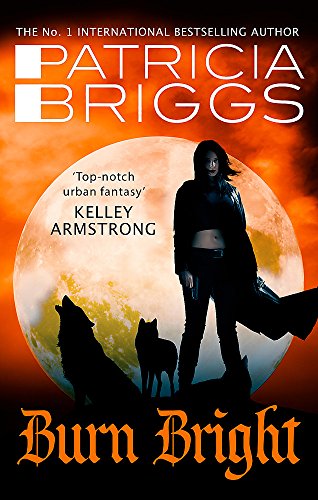 "Book cover featuring a woman and two wolves against a full moon."