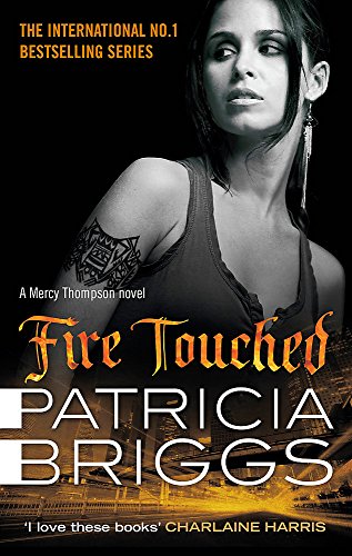 Book cover featuring a woman with a tribal arm tattoo against a city background.