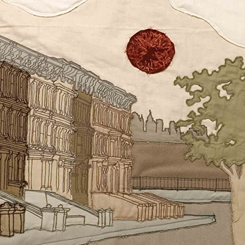 Embroidered cityscape with a red sun, representing the album cover.