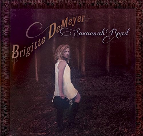 "CD cover featuring a woman in a forest, wearing white top and black pants."