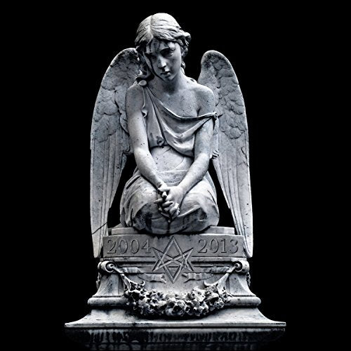 A stone angel statue with wings, inscribed with "2004 - 2013" on a dark background.