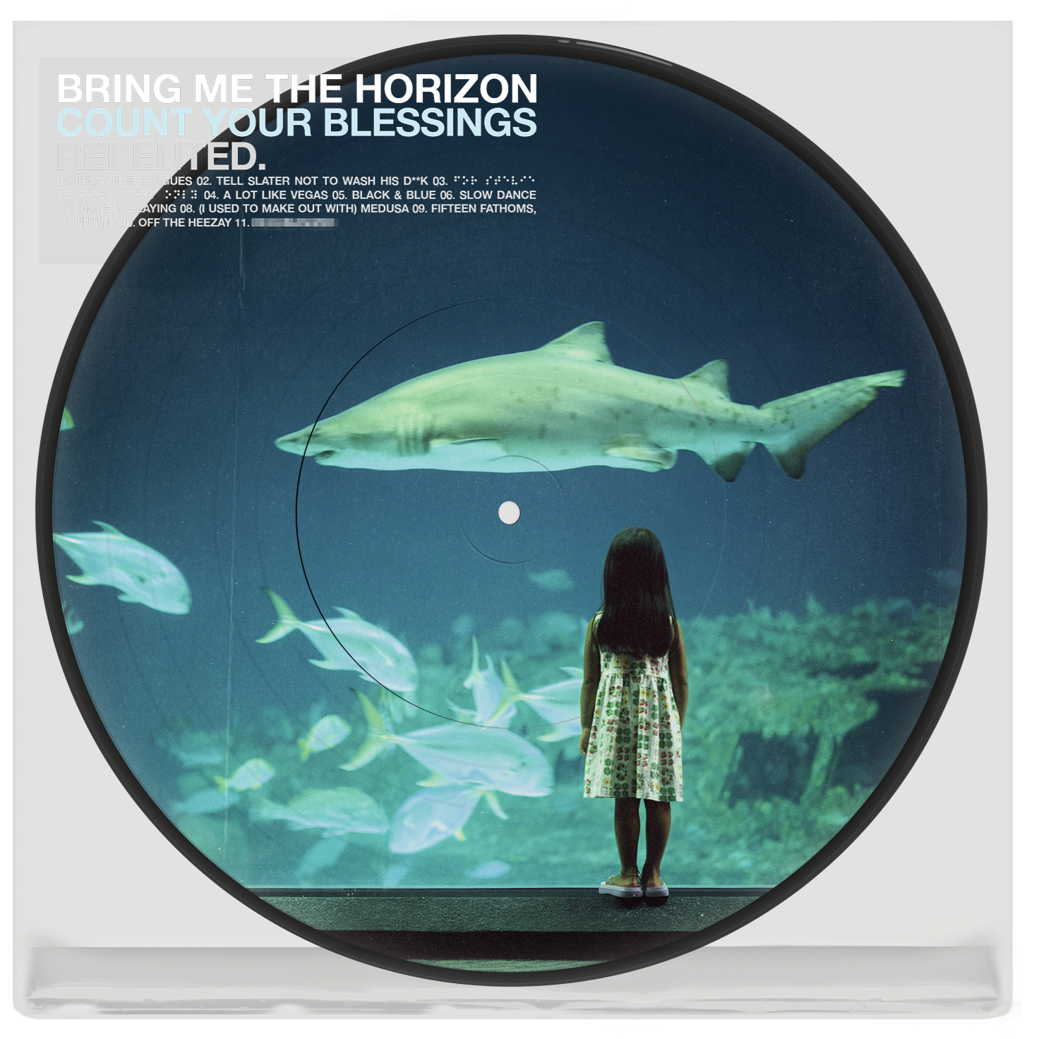 Vinyl record with image of a girl viewing sharks in an aquarium.