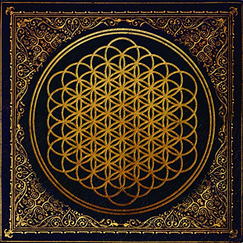 Gold floral pattern on a dark square album cover.