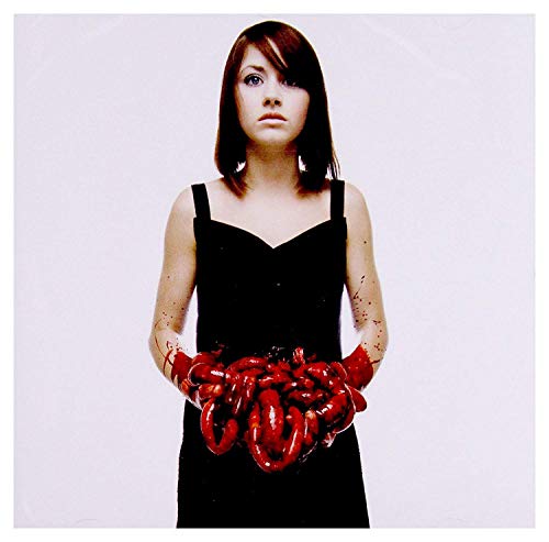 Woman holding organs in front of band name and album title.