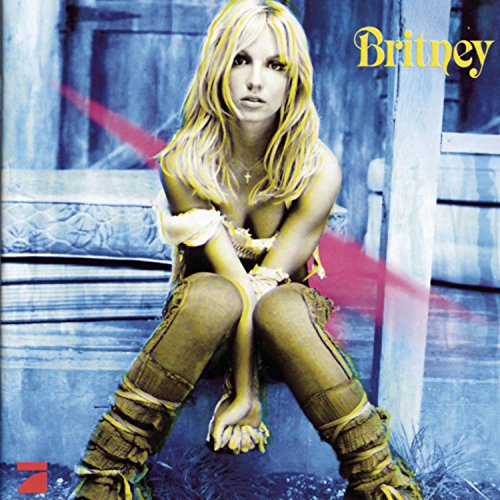Britney Spears album cover, blonde hair, denim outfit, seated pose.