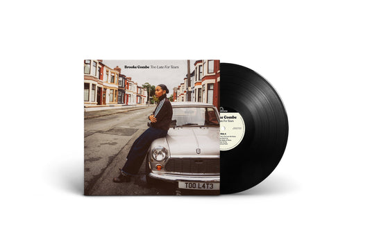 Vinyl record and album cover featuring a woman with a classic car.