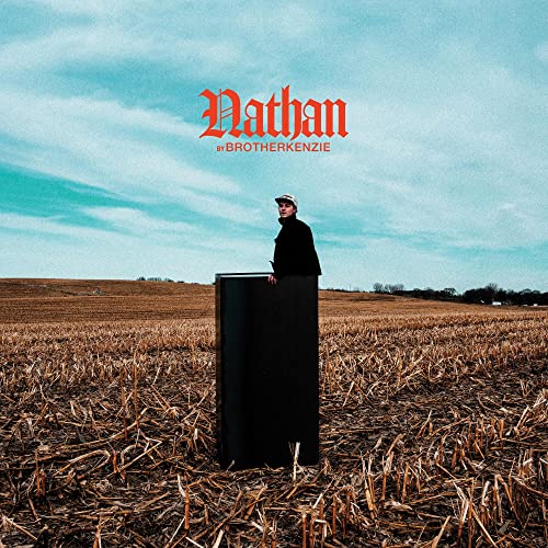 Album cover: person standing by a black rectangle in a field.