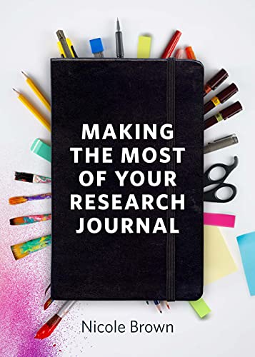 Black research journal with pens, pencils, and colorful art supplies.